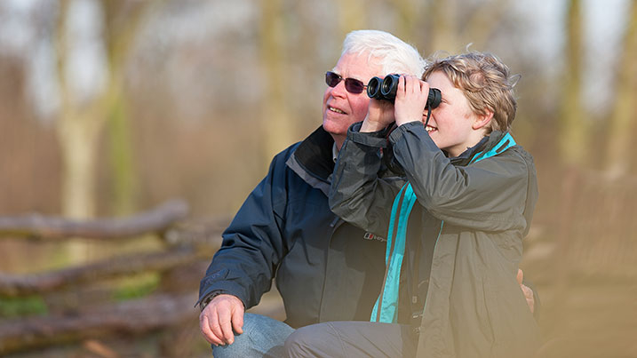 A man and child birdwatching