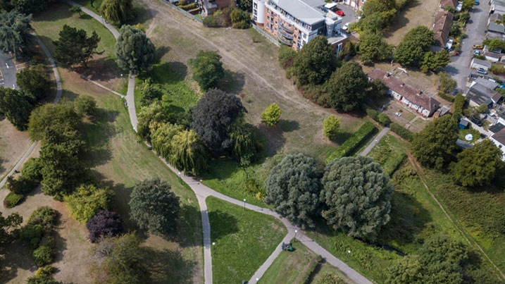 An aerial shot of some parkland near some buildings